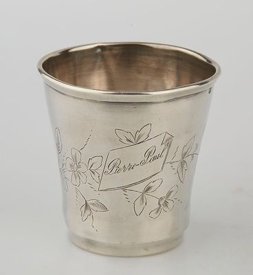 a silver cup with a bird on it sitting on top of a table