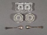 four pieces of silverware are arranged on a table