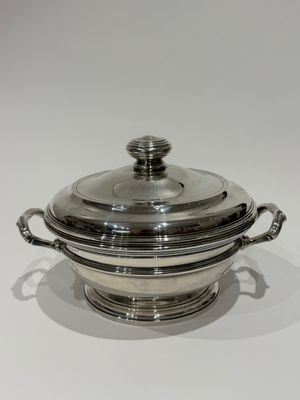 a silver plated casserole with a lid and handles