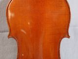 an antique violin with a wooden back and a wooden bow