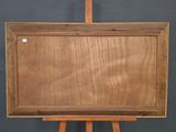 an old wooden easel with an empty wooden board on it