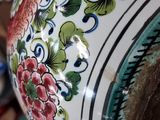 a close up of a decorative vase with flowers on it