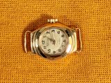 an image of a close up of a watch on a yellow cloth