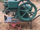 a small green machine that is sitting in the grass