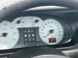a close up of a car dashboard with a clock on it