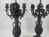 pair of antique cast iron candelabs on pedestals
