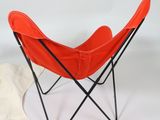 a red chair and a white sock on a white background