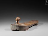 an old wooden bench with a wooden handle on it