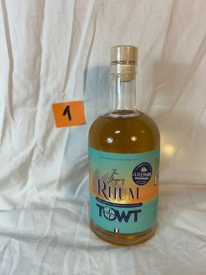 a bottle of liquor sitting on a table with a price tag in front of it