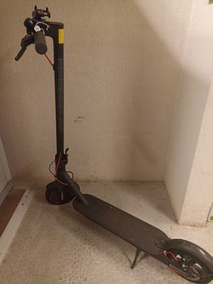 un scooter posé par terre à côté d'une porte