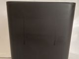 a black laptop sitting on a plastic bag on top of a table