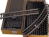 two boxes of train tracks that are sitting on a table