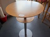 a table and chairs in a room with a large window