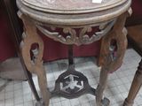 a small table with a marble top and a wooden chair