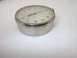 a silver clock sitting on a white table
