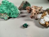 a small green piece of rock next to a small green piece of rock