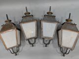 three old fashioned light fixtures mounted on a wall