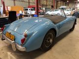 an image of a blue sports car parked in a garage