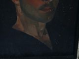portrait of a man in a blue shirt in a black frame