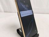 a close up of a cell phone on a stand on a bed