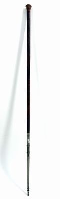 a baseball bat that is leaning up against a white wall