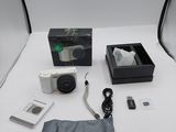 a camera and other items sitting on a white table