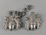 pair of silver acorns with leaves and acorns hanging from a chain