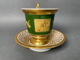 a cup and saucer on a saucer on a table