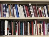 a book shelf with many books on it in a room