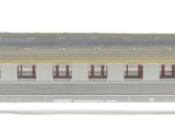 a silver train car with a yellow stripe on the side