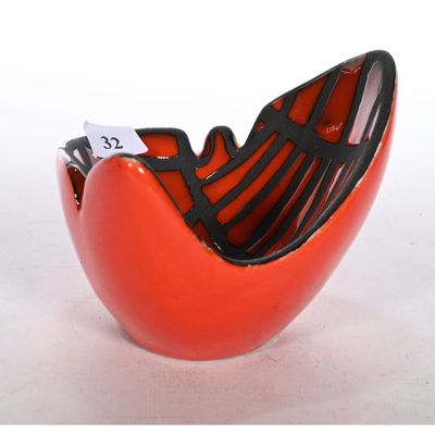 a red bowl with a black handle and a tag on it