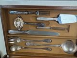 a wooden box with a set of silverware in it