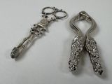 two spoons and a pair of scissors sitting on a table