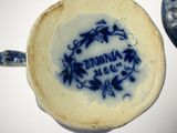 a blue and white cup that has a blue and white design on it
