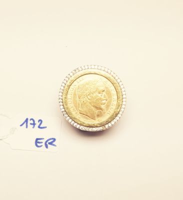 a gold coin sitting on top of a piece of paper