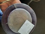 a person holding a silver plate with a label on it