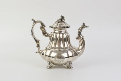 a silver teapot with a bird handle on a white background