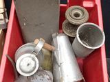 a red container filled with metal items sitting on a table