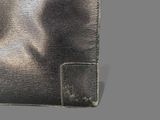 leather wallet on a gray background with a small hole in the middle