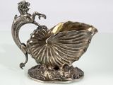 silver plated figurine of a mermaid on a shell