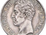 an old silver coin with a woman ' s face on it