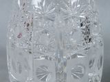 a clear glass vase with a flower design on it