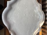 a white plate sitting on top of a wooden table