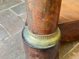 a close up of a wooden table with a metal ring on it