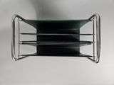 a metal shelf with a glass shelf on top of it