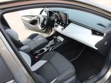 the interior of a car with the door open and the driver ' s seat down