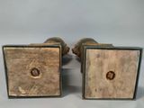 pair of antique brass and wood bookends with holes in them