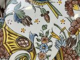 a plate with a bird and flowers on it