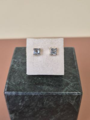 a close up of a pair of earrings sitting on top of a box