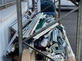 a pile of junk in a parking lot next to a building